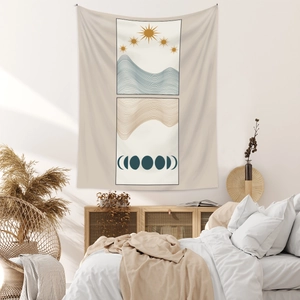 Detail of beige bohemian tapestry featuring sun, mountain waves and moon phases over a bed