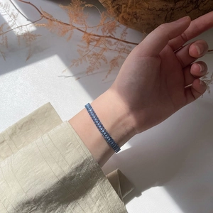 Close-up of triple-row mermaid blue crystal bracelet in shimmering silver setting