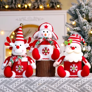 Detailed view of Christmas doll gift bags with Santa, Snowman and Reindeer designs