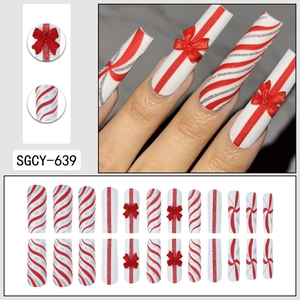 Christmas red bow press-on nails set with silver glitter and striped festive patterns