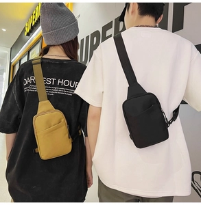 Detail of yellow and black cross-body chest bags with adjustable wide shoulder straps