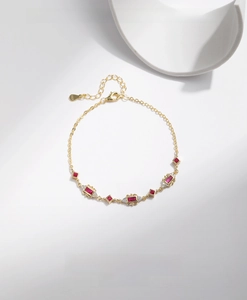 Macro shot of S925 silver bracelet featuring ruby-red gemstone and sparkling zircon stones
