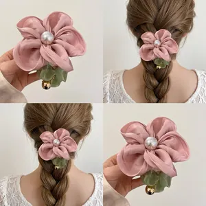 Pink fabric floral scrunchie with large pearl accent and green mesh leaf detail