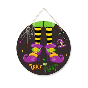 Close-up of Halloween round wooden sign with witch legs and Trick or Treat text