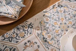 Detailed texture of Moroccan geometric table runner on wooden surface with tableware