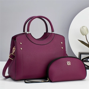 Elegant mulberry leather tote bag and clutch set with gold floral metal detail
