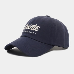 Detailed close-up of 3D letter embroidery on a navy blue cotton baseball cap