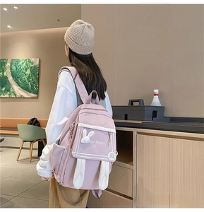 Pink rabbit ear backpack for girls showing side view and large storage pocket
