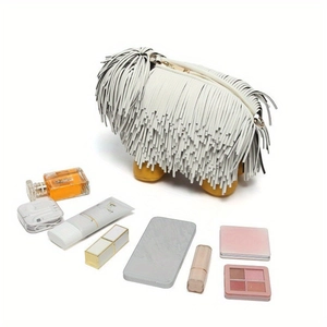 Creative sheepdog fringe handbag for women with accessories on a white background