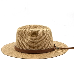 Detailed texture of straw Panama hat with brown leather band and knot tassel detail