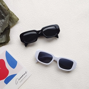Detail view of vintage square frame children sunglasses in classic black and white colors