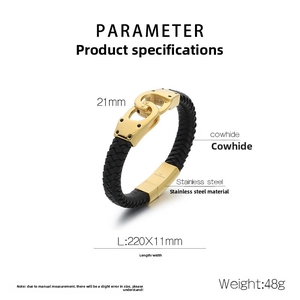 Detail of black leather braided bracelet featuring golden vacuum plated handcuffs buckle
