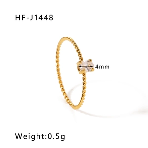 Detail of a 4mm oval white zircon on a gold-plated twisted rope stainless steel ring