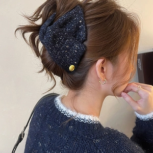 Elegant navy tweed triangle hair claw clip with gold metallic accents on an Asian model