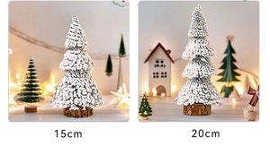 Detail view of snowy flocked cedar Christmas trees in 15cm and 20cm sizes with wood bases