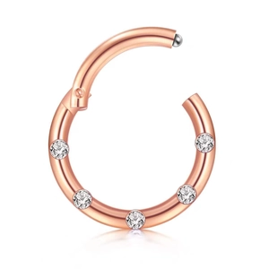 Detailed close-up of rose gold seamless piercing ring with inlaid sparkling clear stones