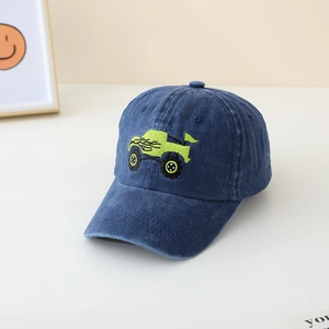 Close-up of children's blue denim baseball cap with green monster truck embroidery