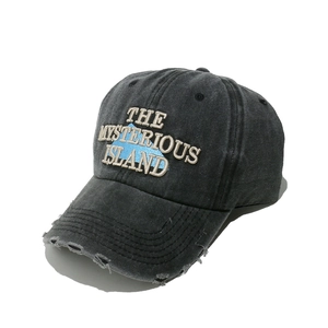 Close-up of vintage washed baseball cap with Mysterious Island 3D embroidery and distressed brim