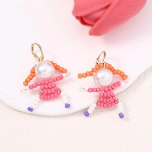 Handmade beaded cartoon girl earrings with white pearls and colorful beads on white background