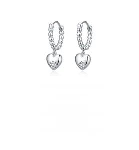 Detail of s925 silver heart dangle earring with sparkling star-set zircon on white background