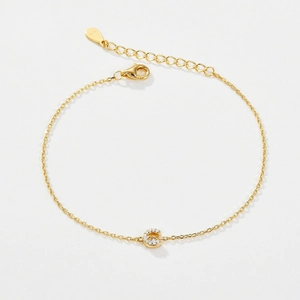 Detail of 925 silver gold bracelet with a sparkling zircon letter C pendant close-up