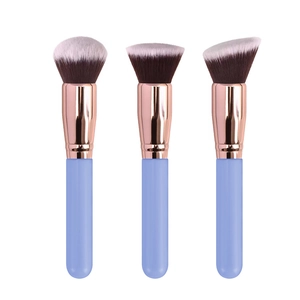 Three professional makeup brushes with rose gold ferrules and light blue handles