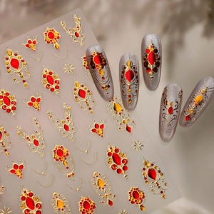 Vintage gemstone nail art stickers with gold starburst patterns on transparent backing