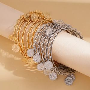 Five-piece stackable metal bangles with vintage coin pendants in gold and silver finish