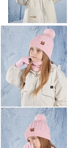 Close-up of pink knit winter set showing the cable pattern and soft texture