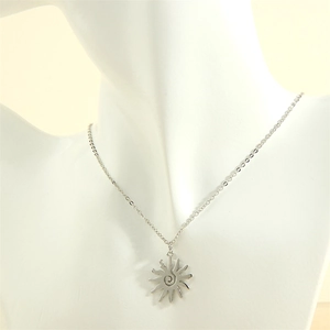 Polished silver sun pendant necklace with spiral motif shown on a mannequin bust