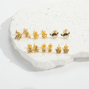 Golden stud earrings set featuring butterfly, leaf, and rainbow girl designs on stone stand