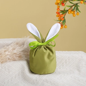 Detailed close-up of green velvet Easter rabbit ear gift bag with ribbon bow
