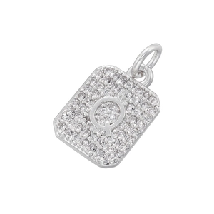 Macro shot of silver square pendant with pavé zircon stones and raised letter Q