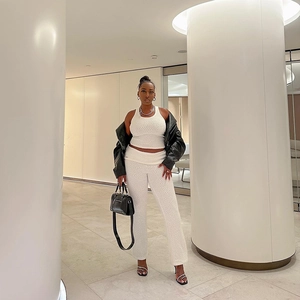 Detail of white textured knit two-piece set featuring slim vest and matching trousers