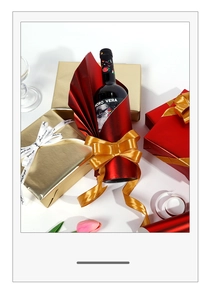Detail of red and gold metallic gift wrapping paper with decorative luxury ribbons