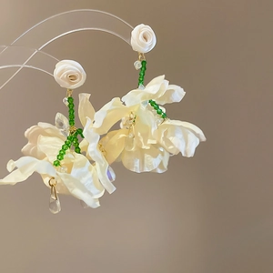 Handmade white chiffon flower earrings with green beads and gold tassels