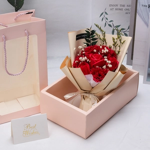 Preserved red soap flower bouquet with roses and carnations in a pink gift box with bag