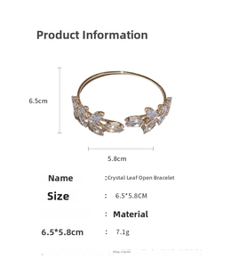 Detailed view of leaf open bangle with measurements in gold alloy and crystals