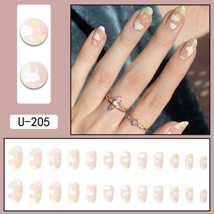 Short oval press-on nails with pink base color and white cloud yellow star patterns