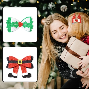 Detail of glitter Christmas hair clips featuring reindeer antlers and holiday bow motifs