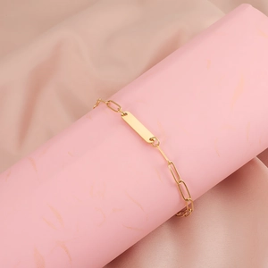 Minimalist gold stainless steel paperclip chain bracelet with a polished ID bar plate