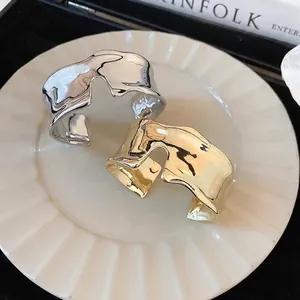 Minimalist wide open cuff bracelets in irregular wavy molten style with gold and silver finish