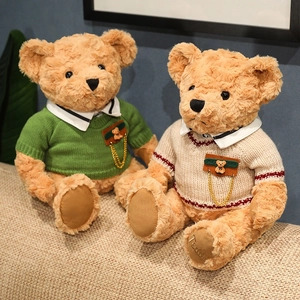 Plush teddy bears wearing knit sweaters sitting on a cozy sofa, graduation gift