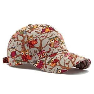 Beige canvas baseball cap featuring owl and branch prints with a classic curved brim