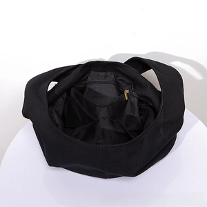 Detail view of the black canvas bag interior featuring a zipper pocket and two slots
