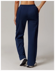 Rear view detail of navy high-waist joggers with pintuck seams and loose straight cut