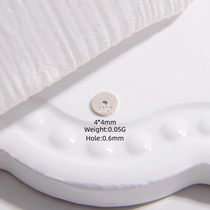 Macro detail of S925 sterling silver 4mm round spacer bead with hallmarked logo