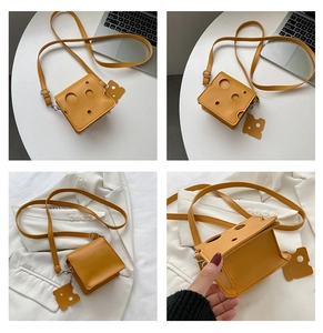 Macro view of a creative yellow cheese-shaped mini crossbody bag in PU leather material