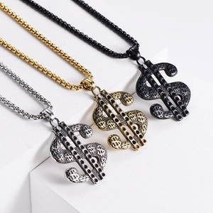 Three hip hop dollar sign pendants in gold, silver and black finishes on white stairs