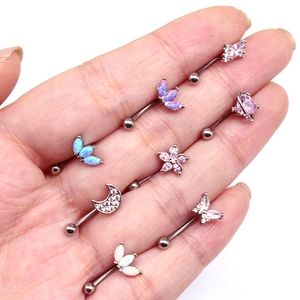 Close-up of eight silver stainless steel eyebrow rings with colorful zircon and opal gems
